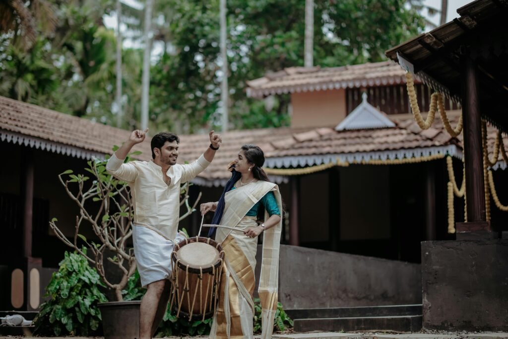 Woman and Man in Traditional Clothing Posing with Drum